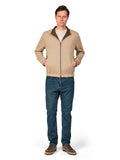 Man wearing a beige jacket and blue jeans on a white background