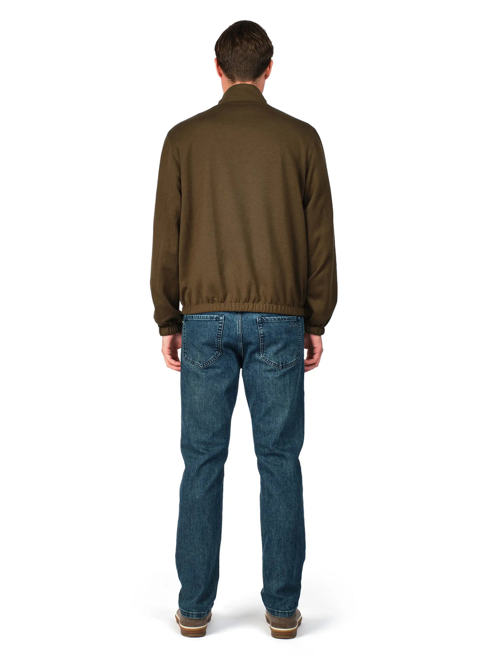 Man wearing a brown jacket and blue jeans on a white background