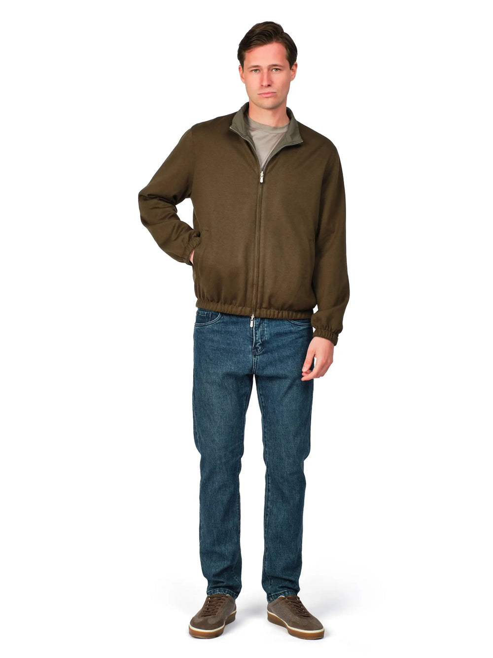 Man wearing a brown jacket and blue jeans on a white background
