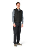 Man wearing a gray sweater, black vest, and dark jeans on a white background