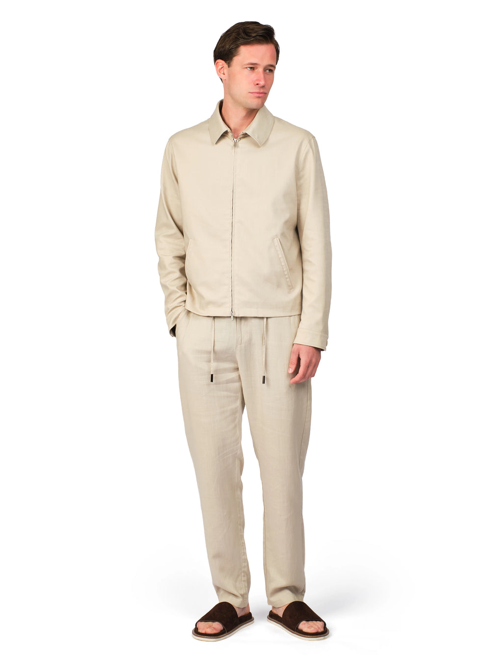 Man wearing a beige suit on a white background