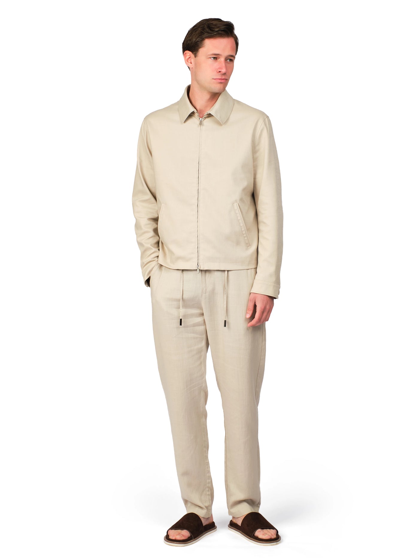 Man wearing a beige suit on a white background