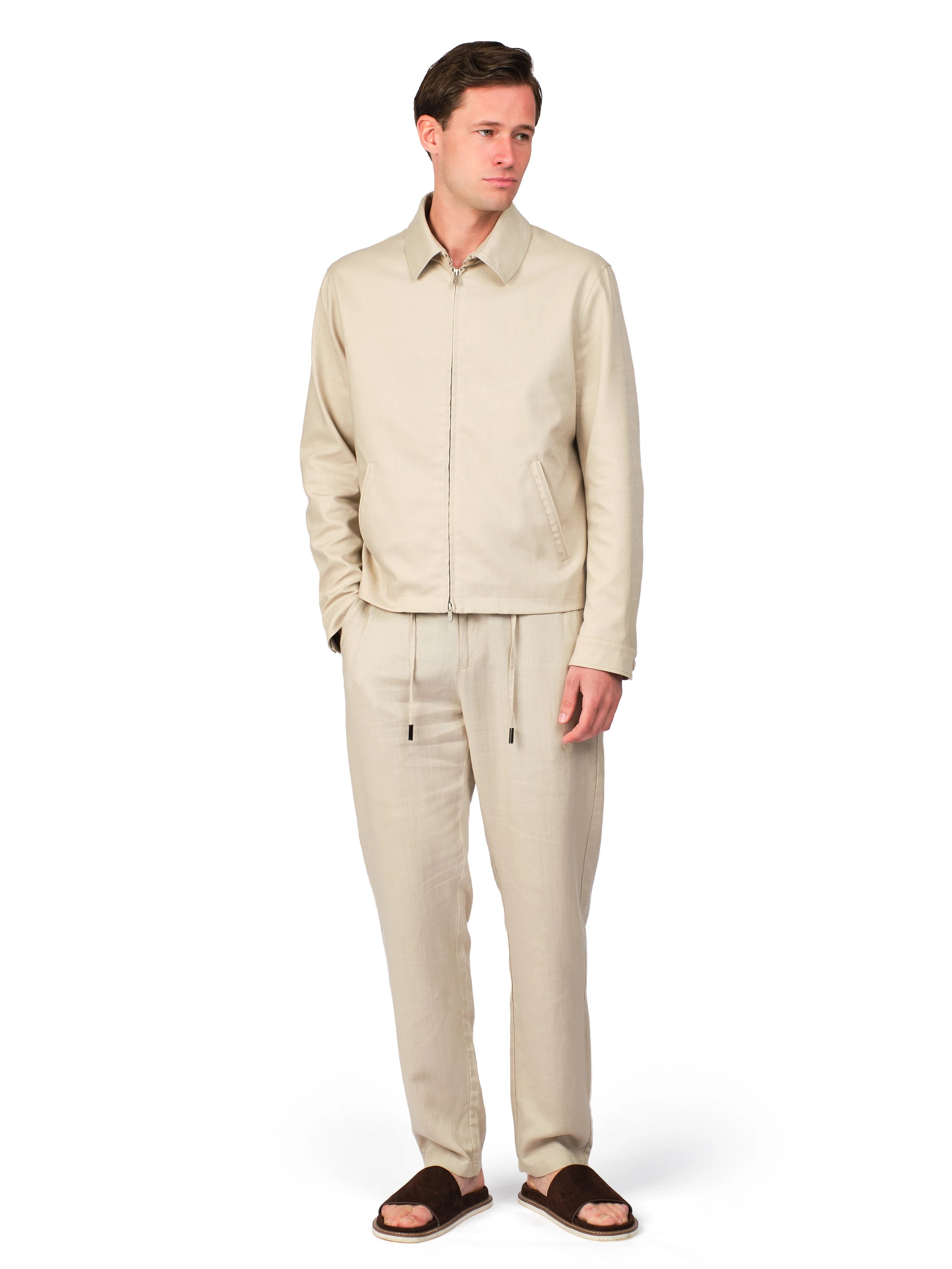 Man wearing a beige suit on a white background