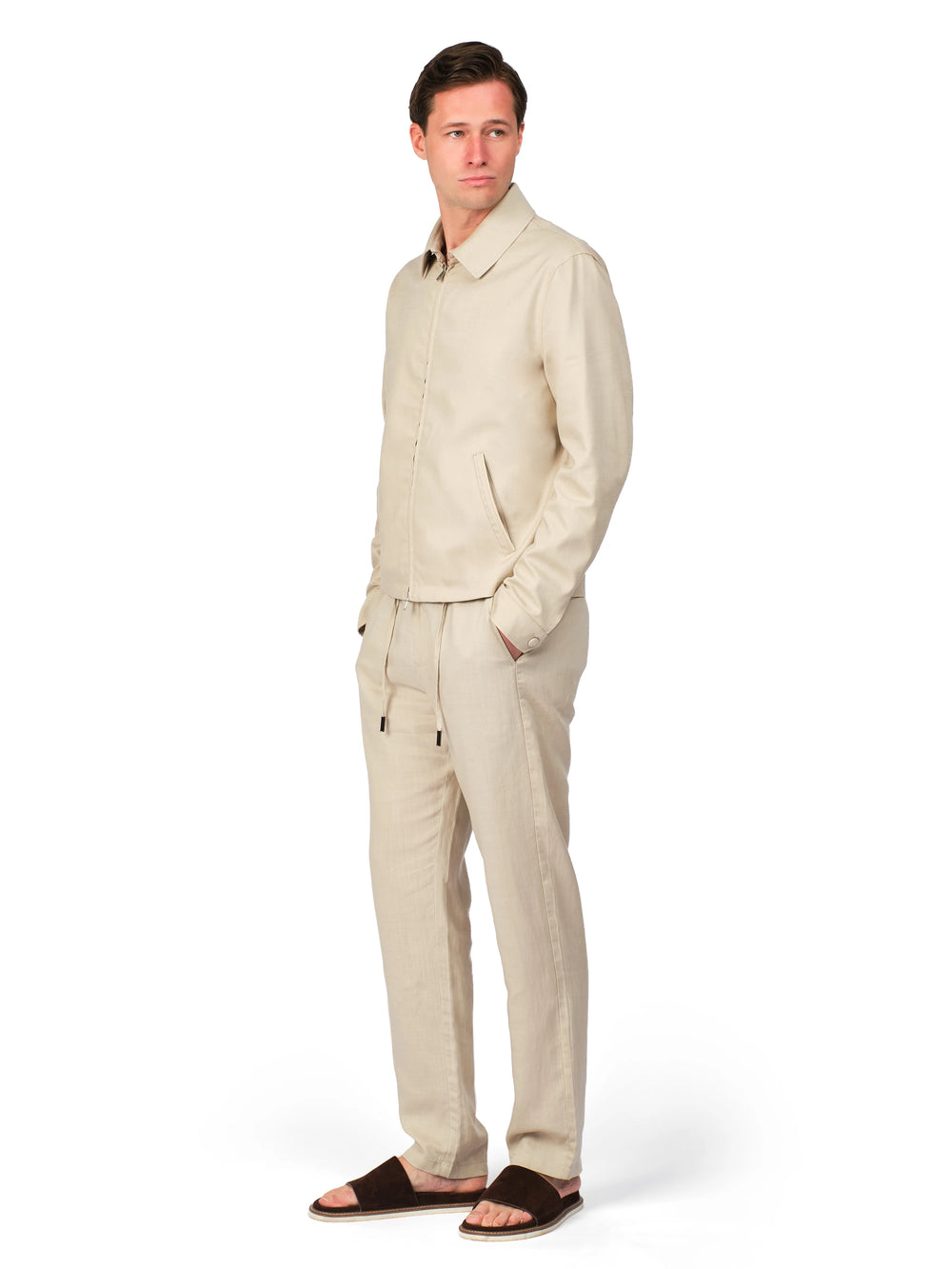 Man wearing a beige linen suit on a white background