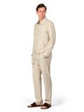 Man wearing a beige linen suit on a white background