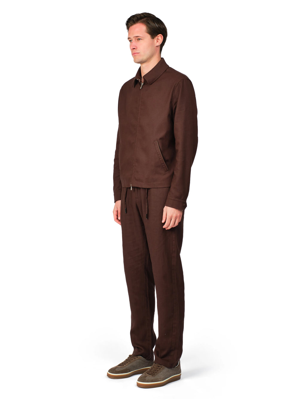 Man wearing a brown outfit on a white background