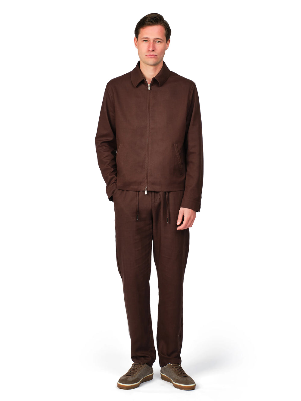 Man wearing a brown tracksuit on a white background