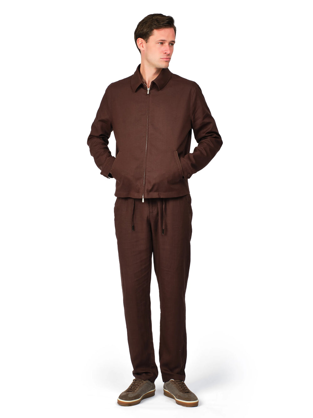 Man wearing a brown tracksuit on a white background