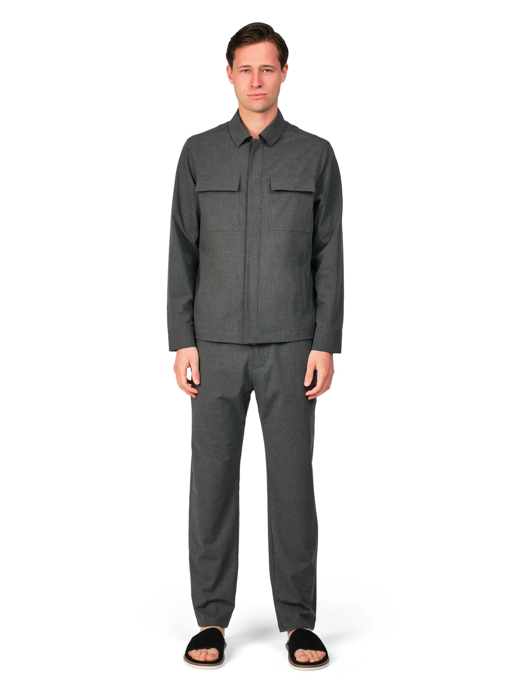Man wearing a gray outfit on a white background