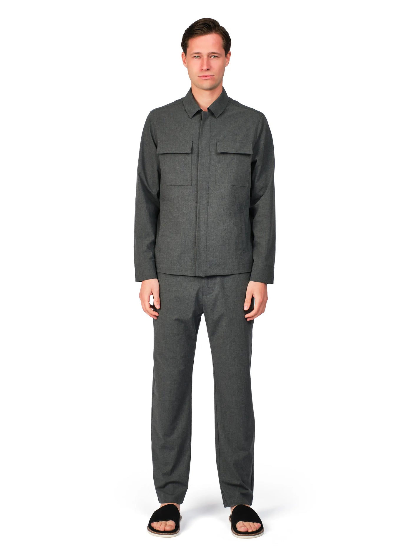 Man wearing a gray outfit on a white background