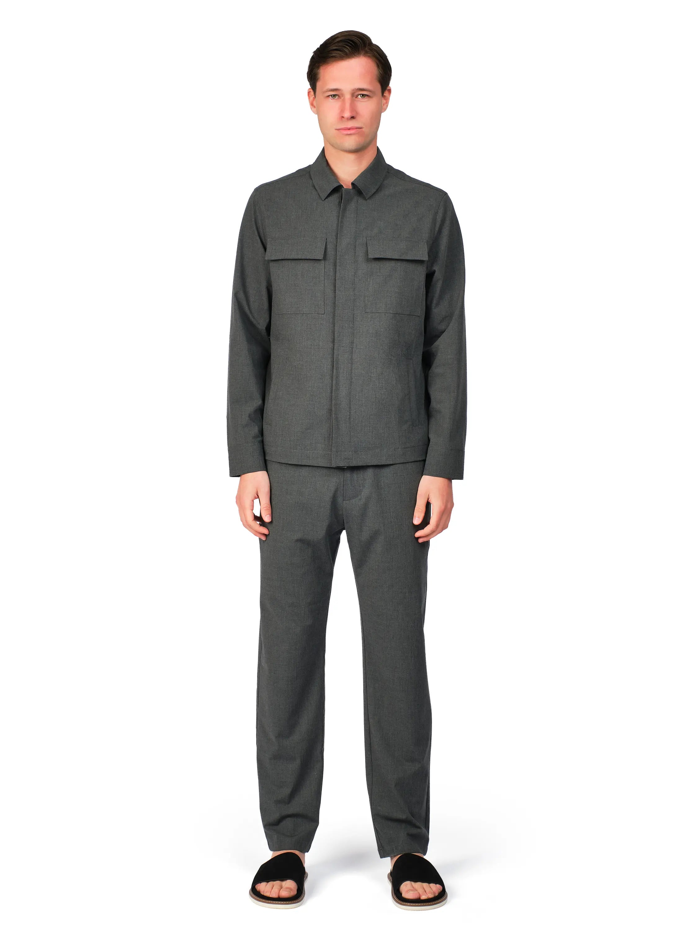 Man wearing a gray outfit on a white background
