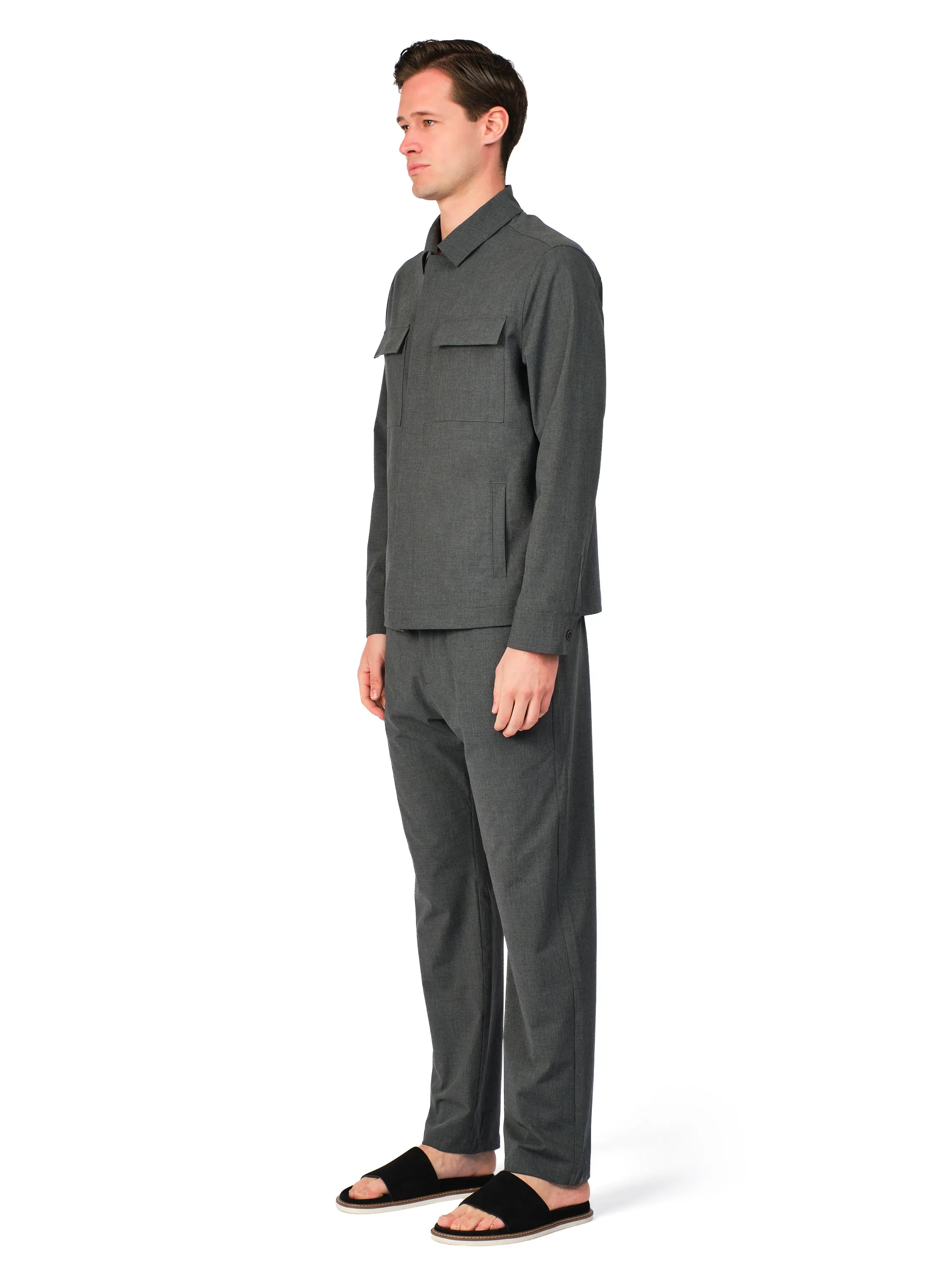 Man wearing a gray outfit on a white background
