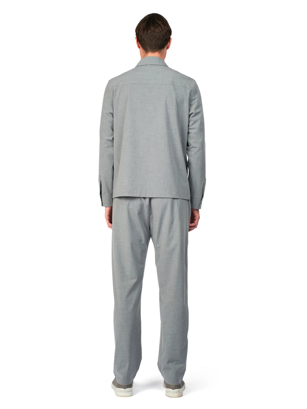 Person wearing a gray suit on a white background