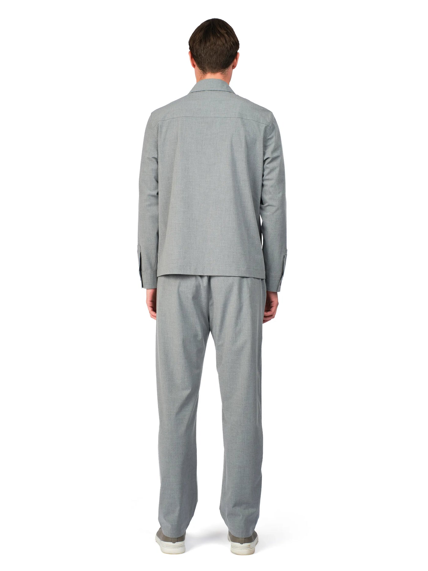 Person wearing a gray suit on a white background