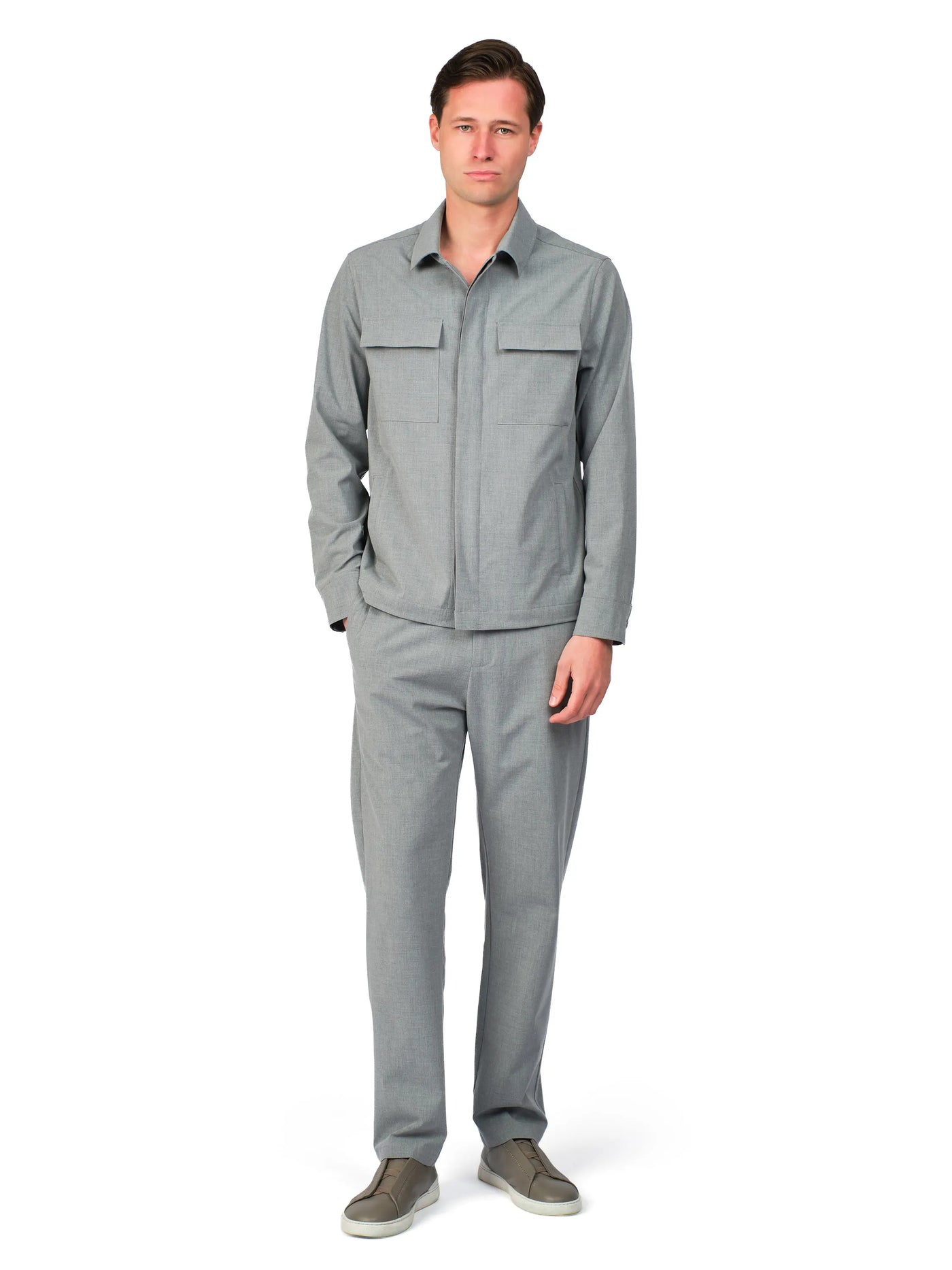 Man wearing a gray outfit on a white background