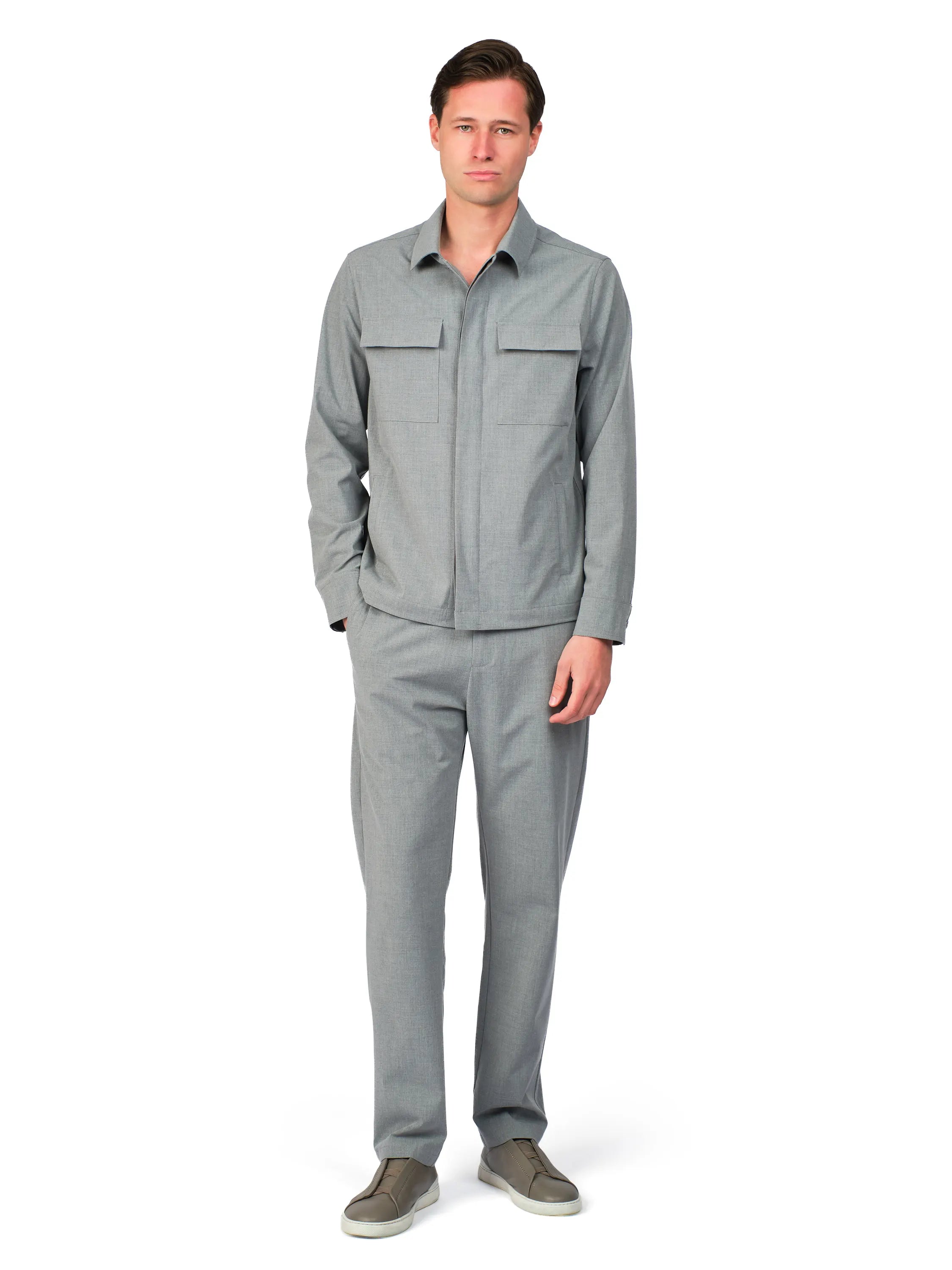 Man wearing a gray outfit on a white background