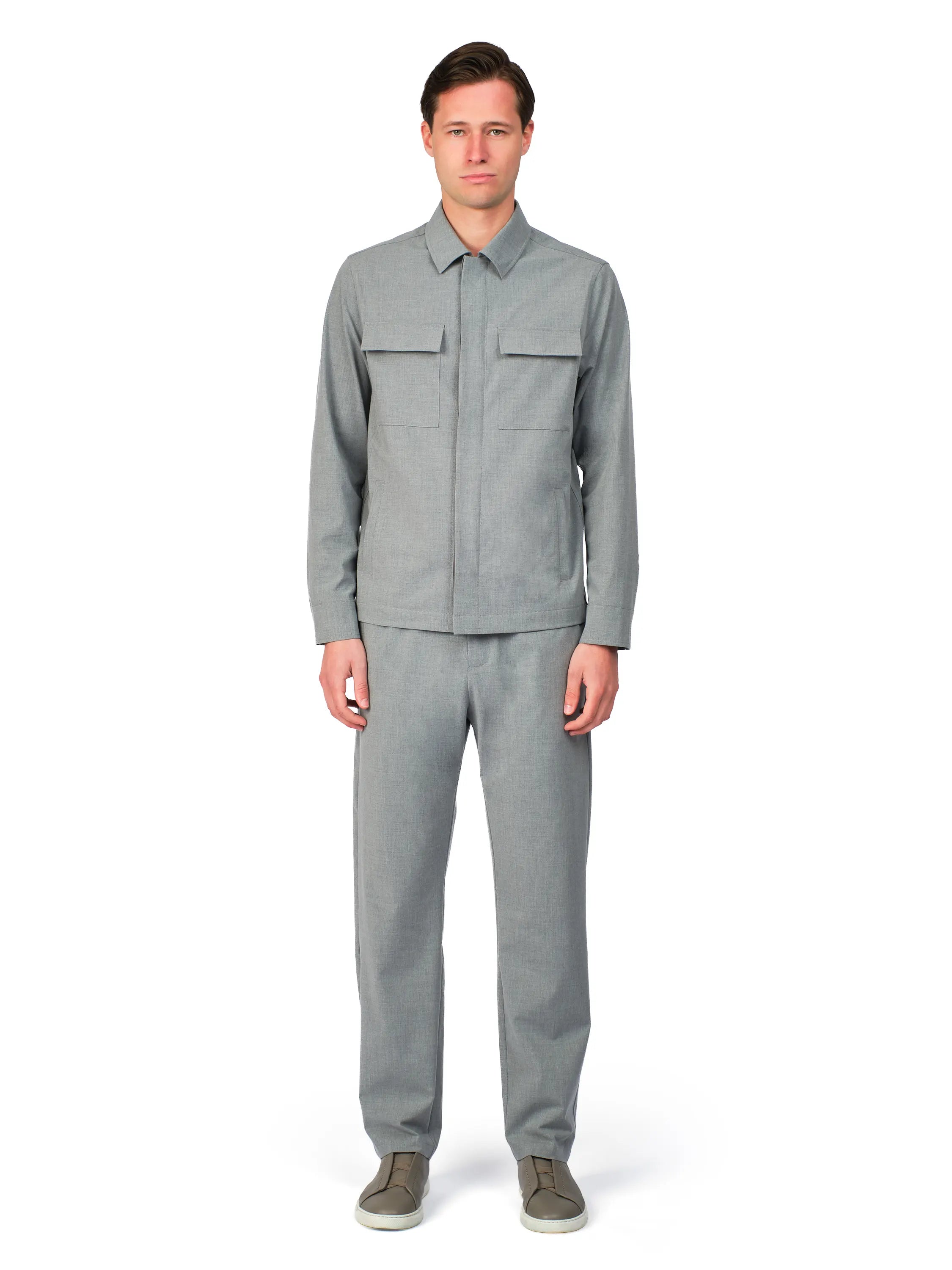 Man wearing a gray outfit on a white background