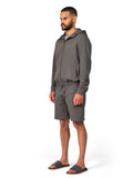 Man wearing a gray tracksuit on a white background
