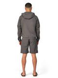 Man wearing a gray tracksuit on a white background