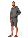 Man wearing a gray tracksuit on a white background