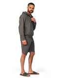 Man wearing a gray tracksuit on a white background