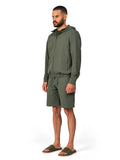 Man wearing a green tracksuit on a white background