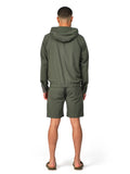 Person wearing a green tracksuit on a white background