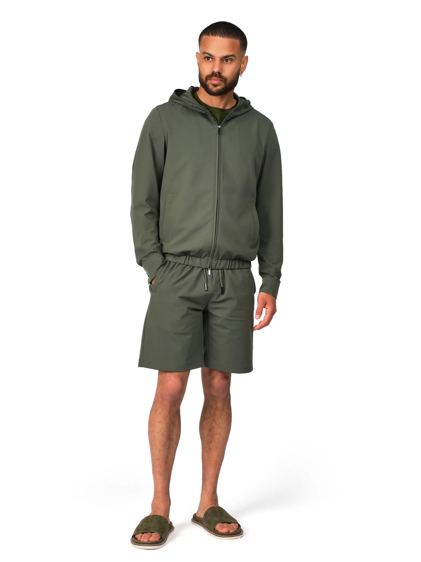 Man wearing a green tracksuit on a white background