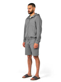 Man wearing a gray tracksuit on a white background