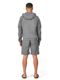 Person wearing a gray tracksuit on a white background