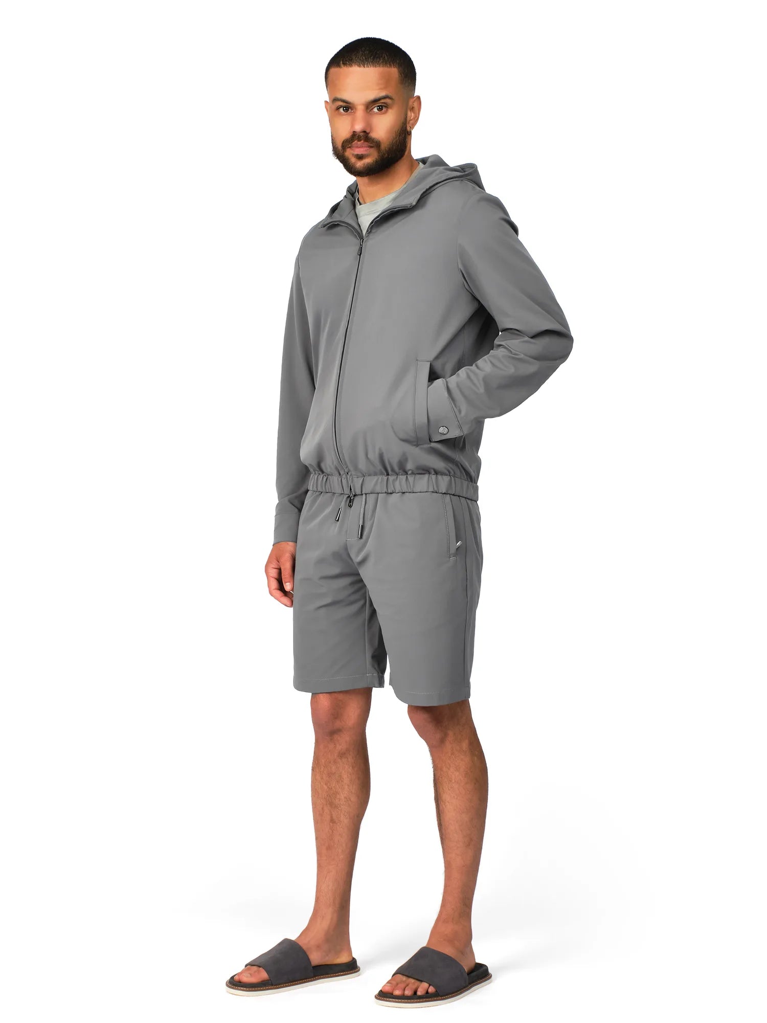 Man wearing a gray tracksuit on a white background