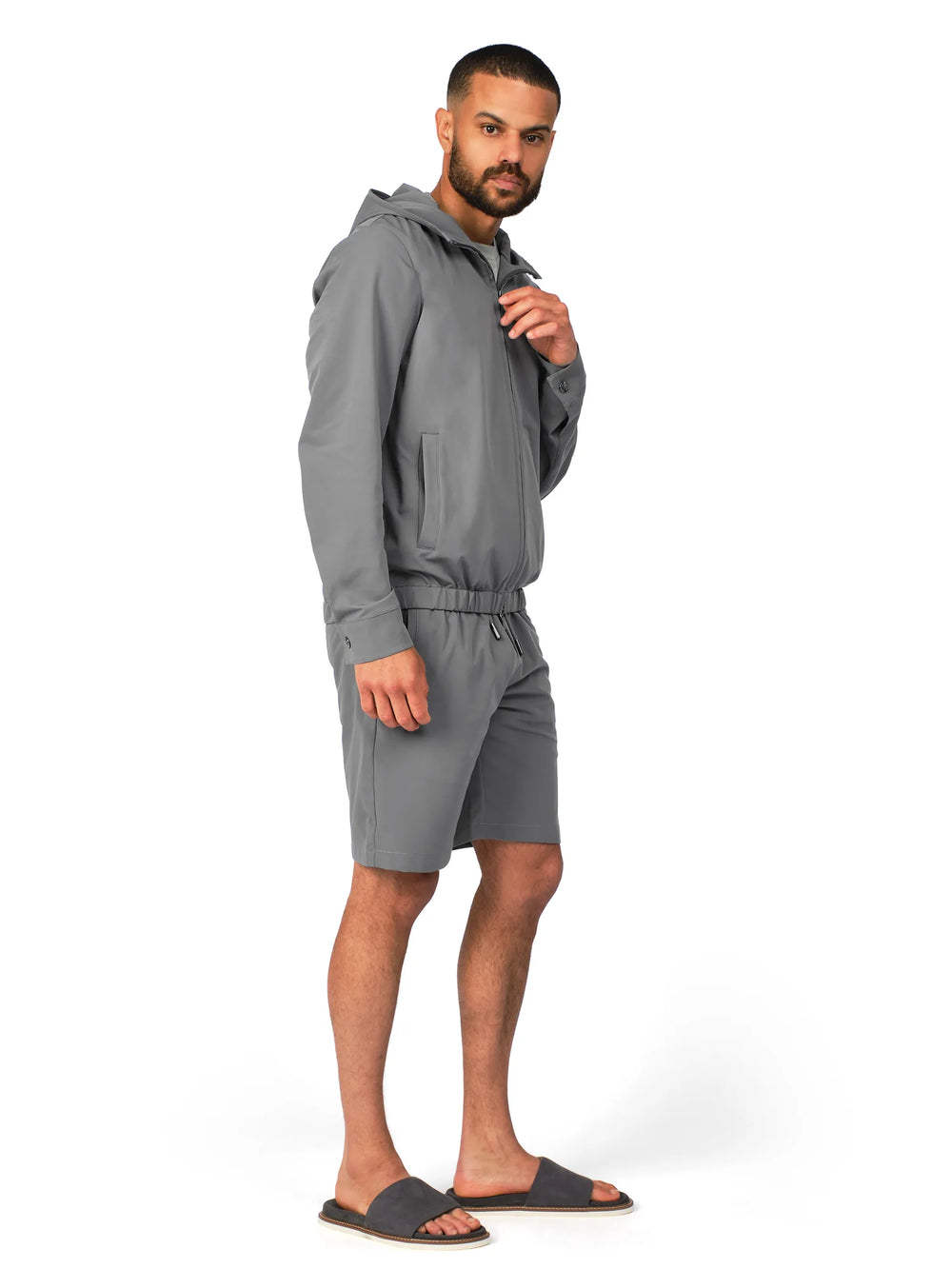 Man wearing a gray tracksuit on a white background
