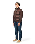 Man wearing a brown puffer jacket and blue jeans on a white background