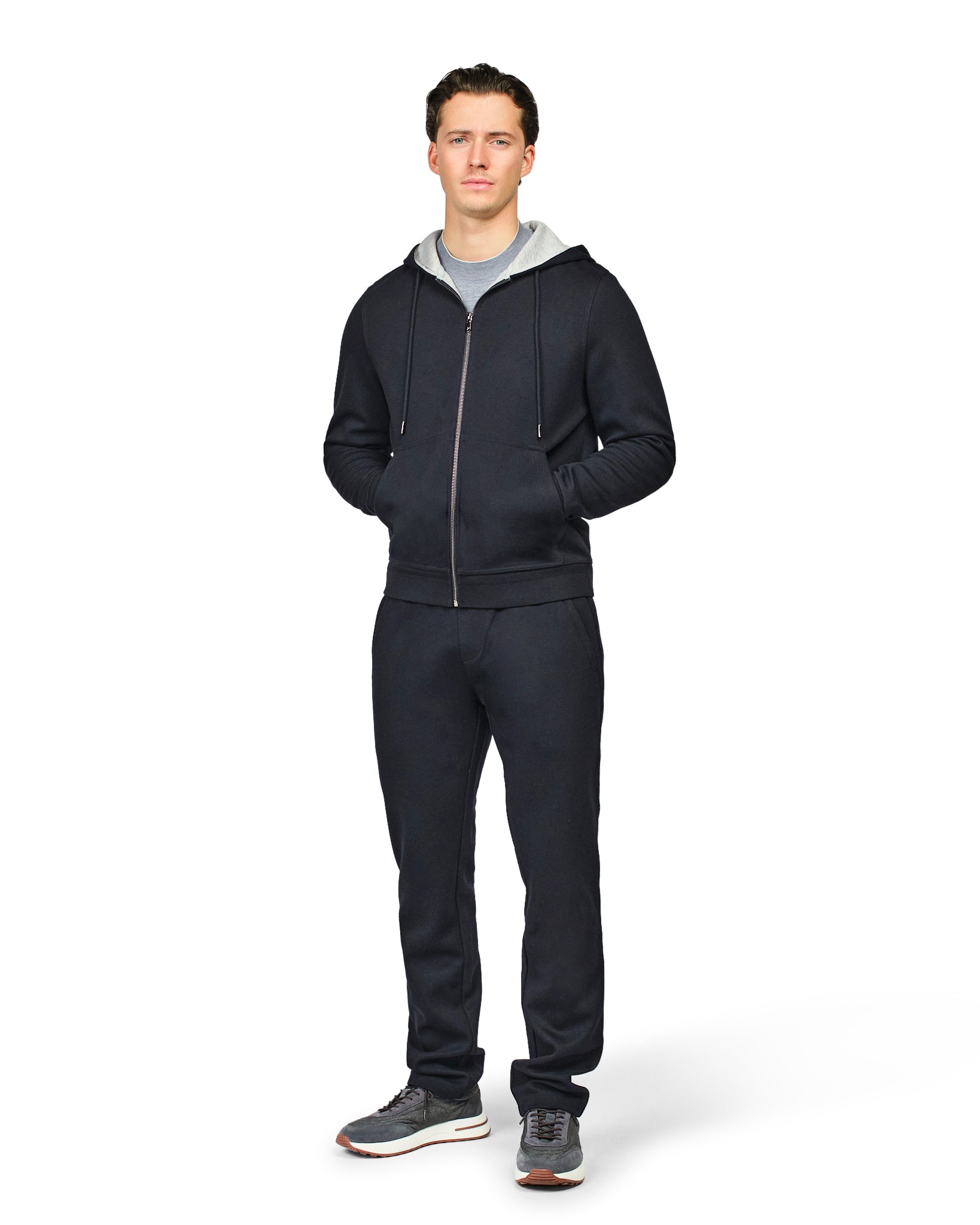 Man wearing a black tracksuit on a white background