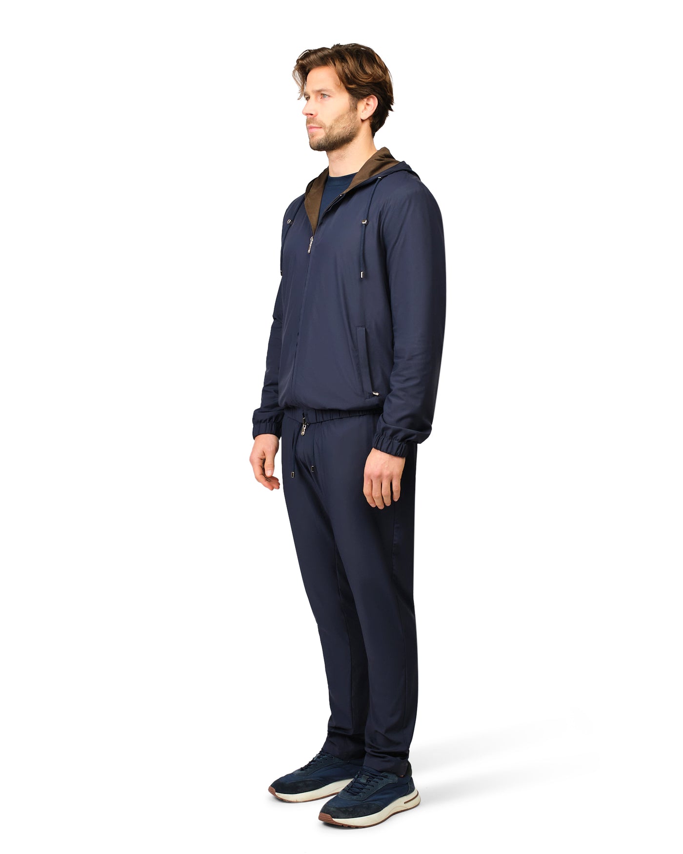 Man wearing a navy blue outfit on a white background