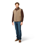 Man wearing a brown vest over a brown shirt with blue jeans on a white background