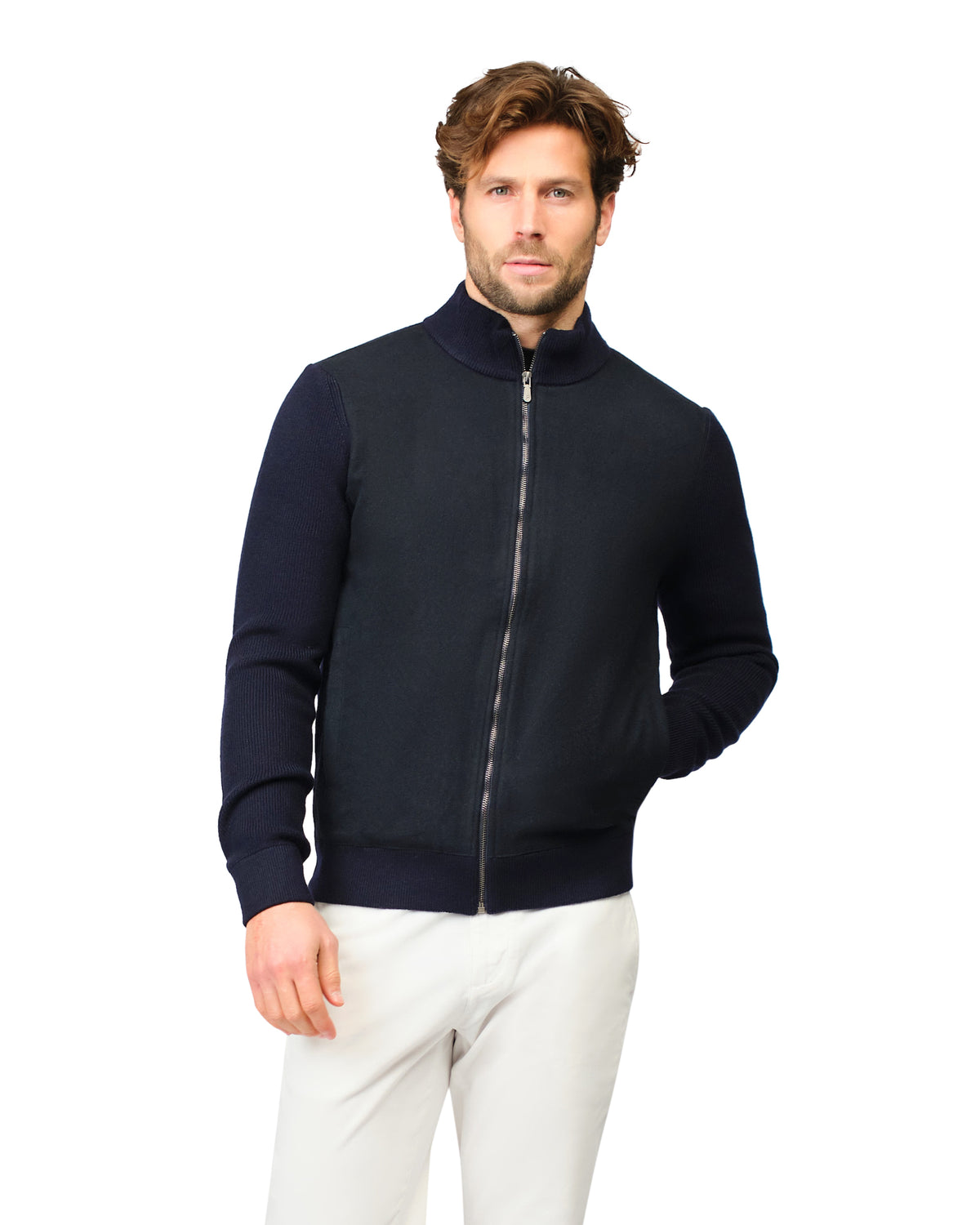 Man wearing a navy blue jacket with a zipper on a white background