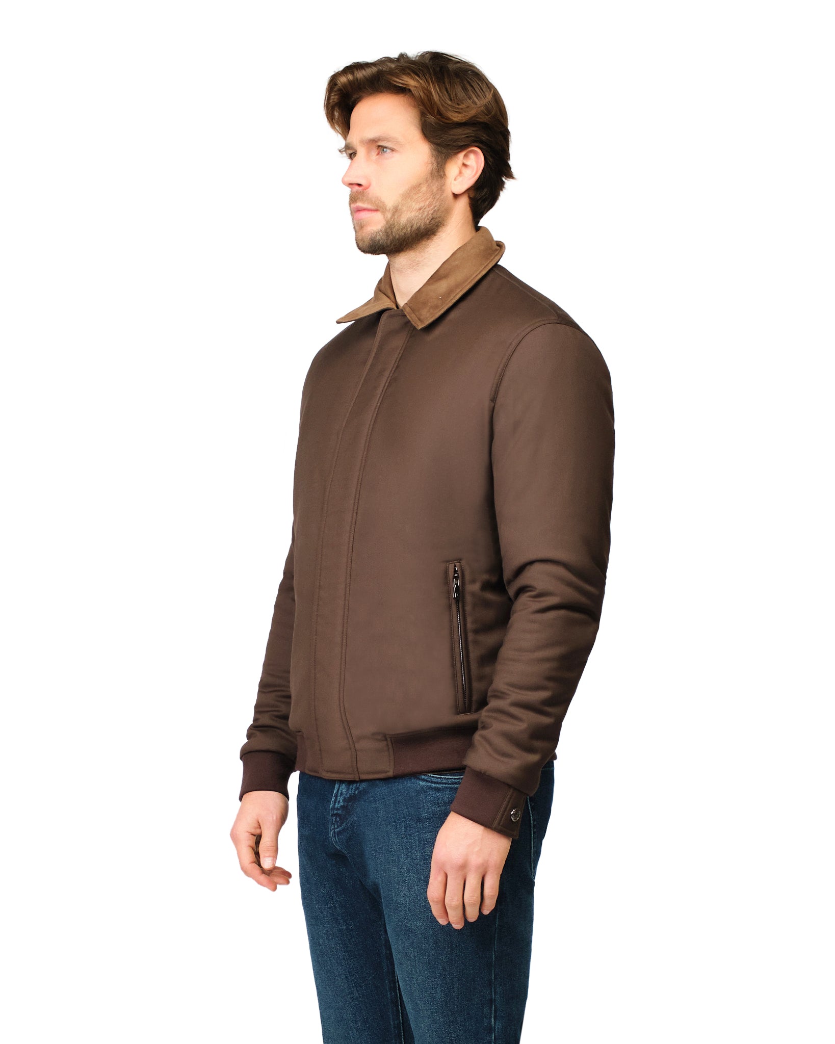 Man wearing a brown jacket and blue jeans on a white background