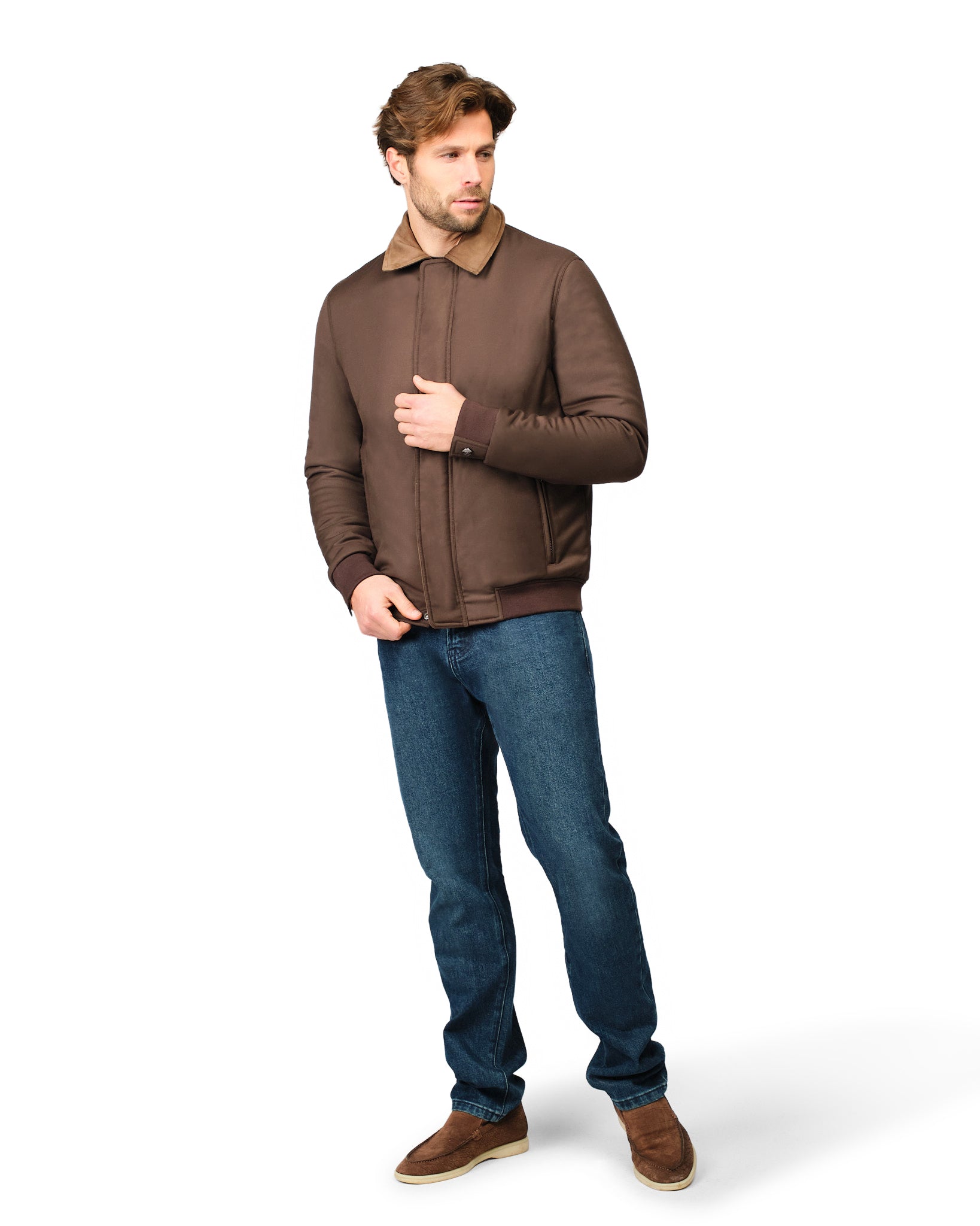 Man wearing a brown jacket and blue jeans on a white background
