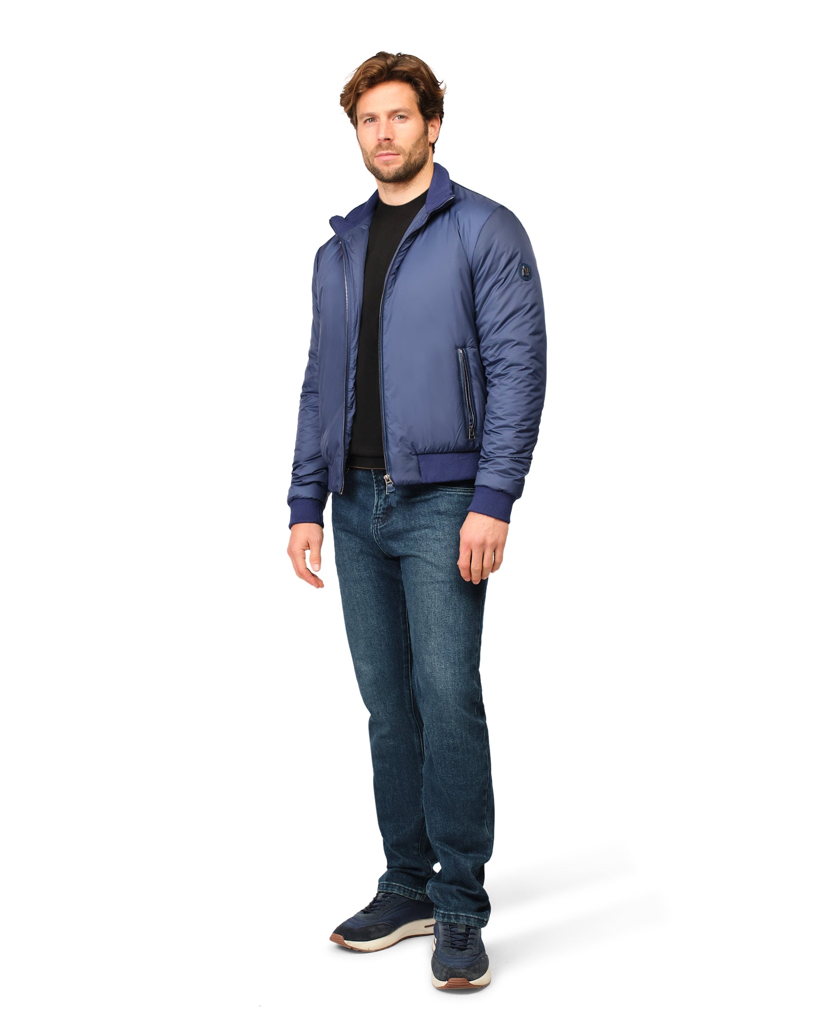 Man wearing a blue jacket and jeans on a white background