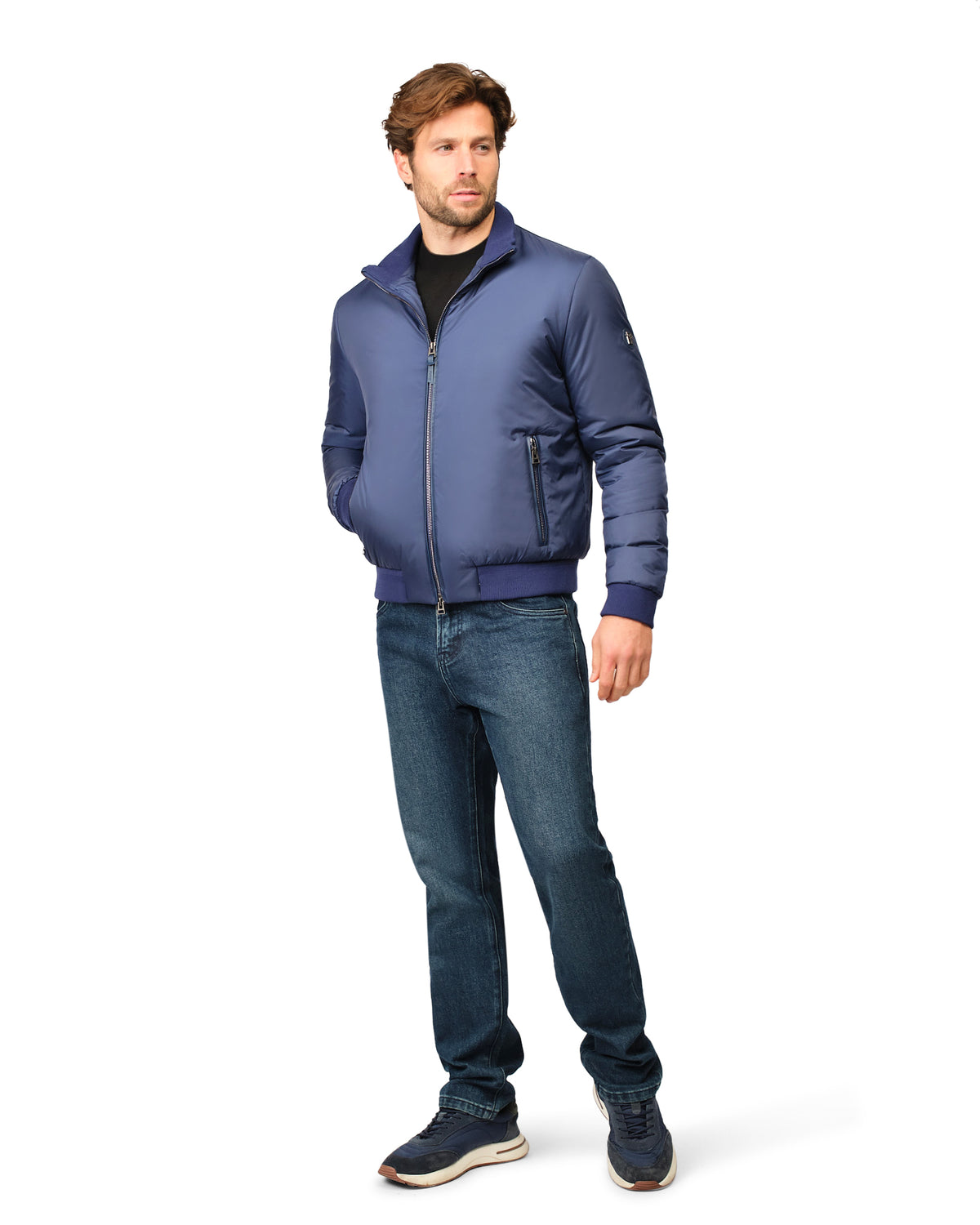 Man wearing a blue jacket and jeans on a white background