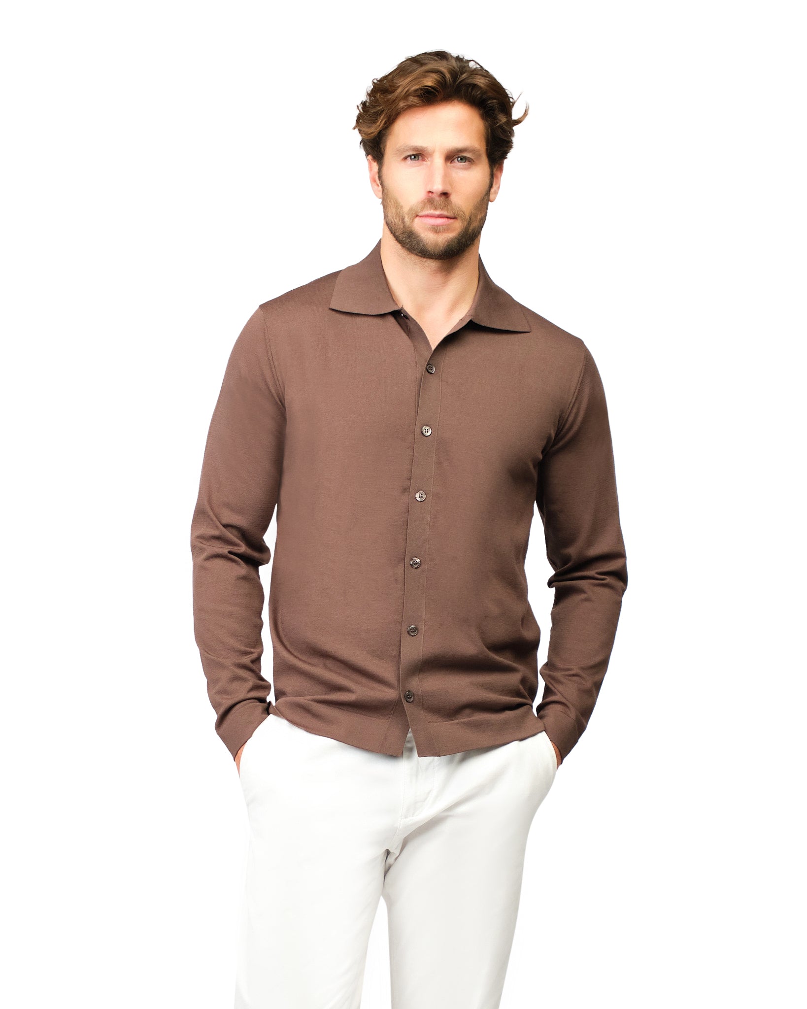 Man wearing a brown long-sleeve shirt and white pants on a white background
