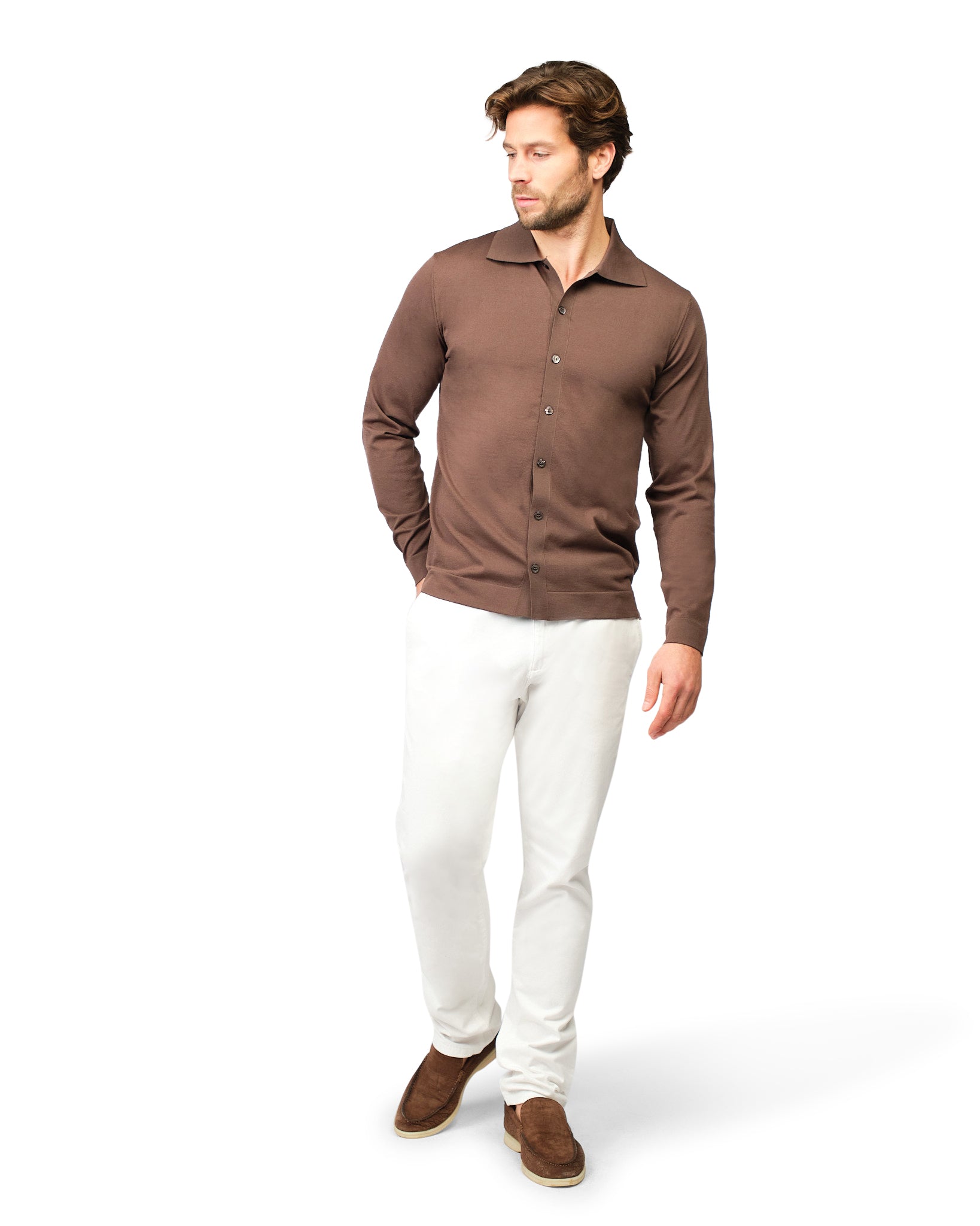 Man wearing a brown shirt and white pants on a white background