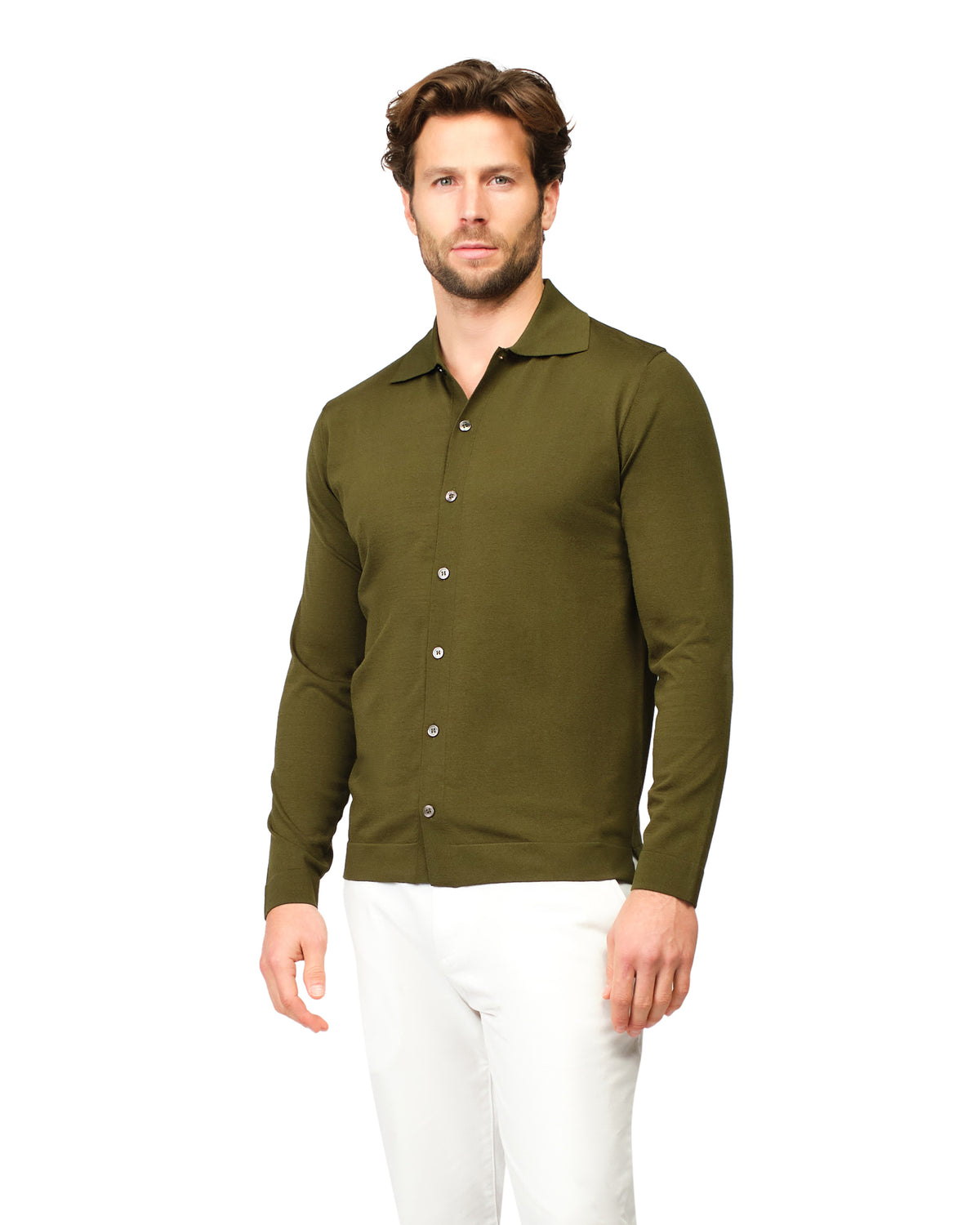 Man wearing a green button-up shirt and white pants on a white background