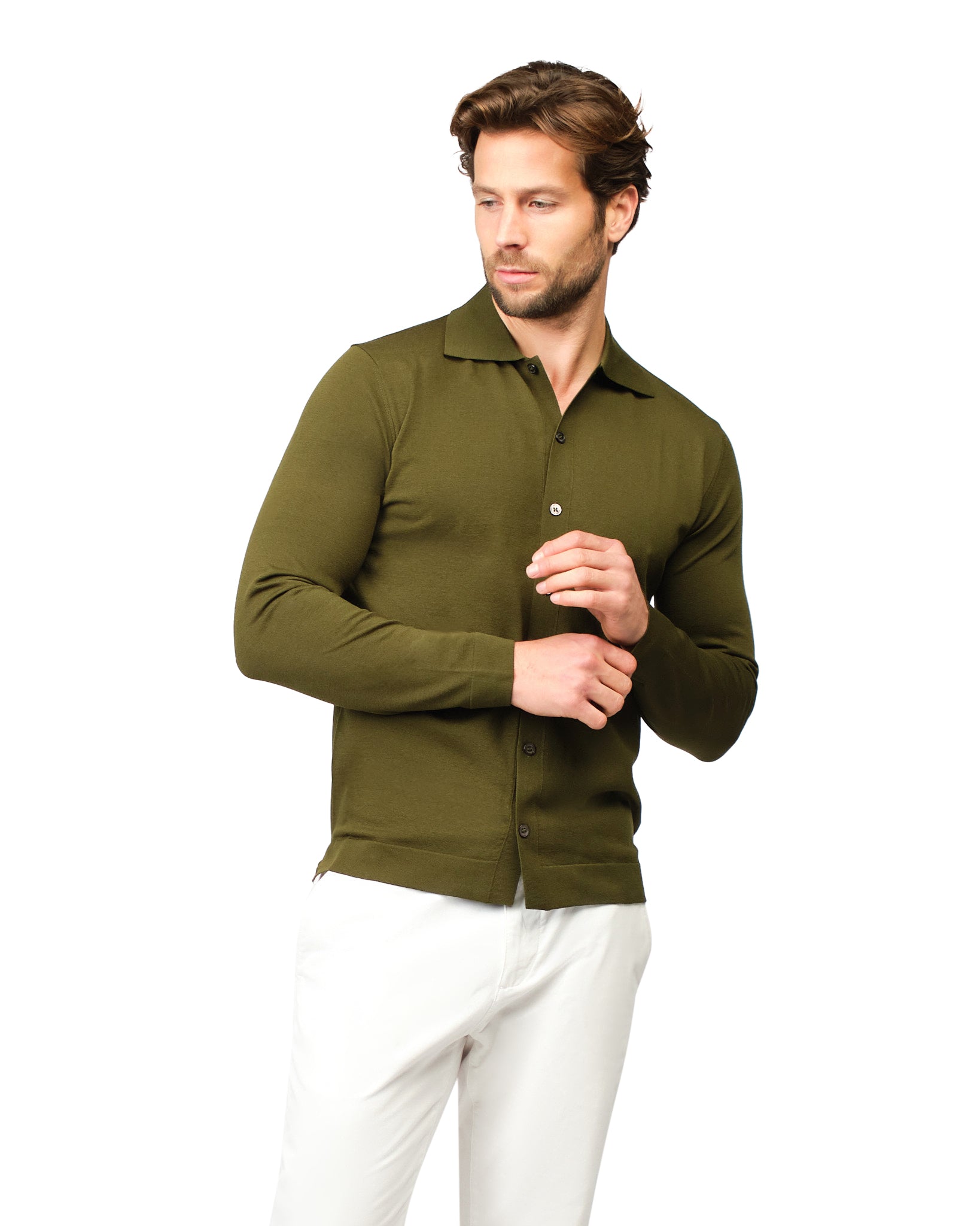 Man wearing a green shirt and white pants on a white background