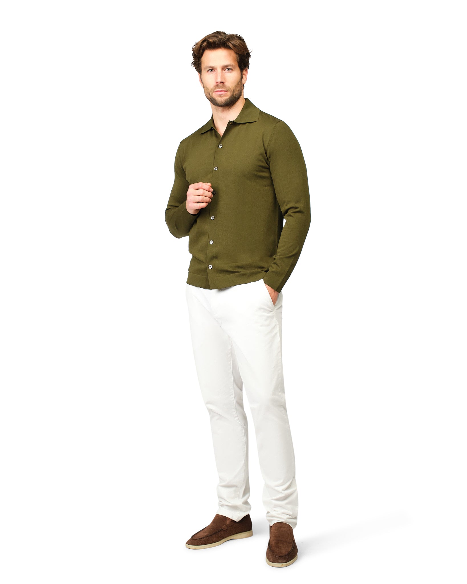 Man wearing a green shirt and white pants on a white background