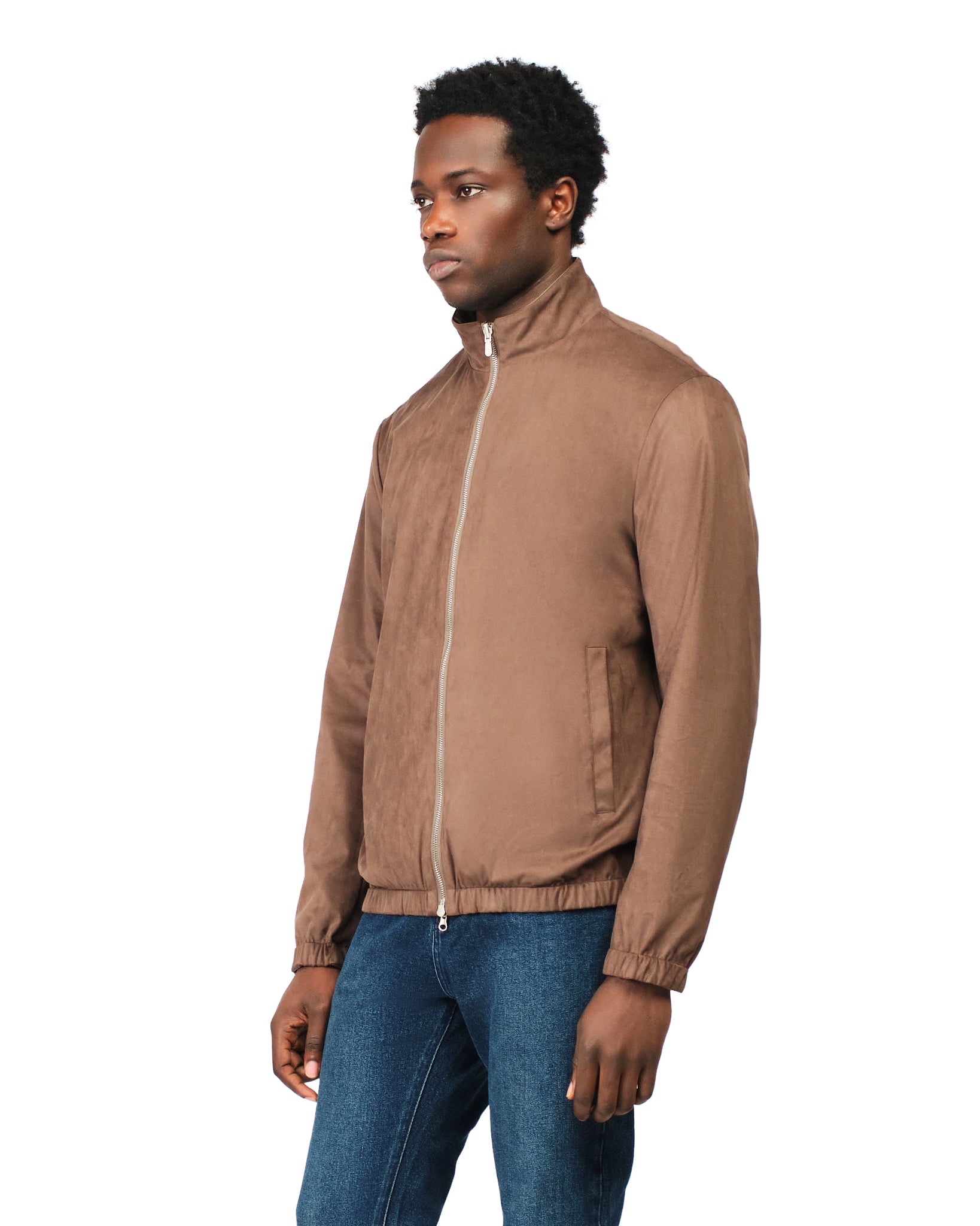 Man wearing a brown jacket and blue jeans on a white background
