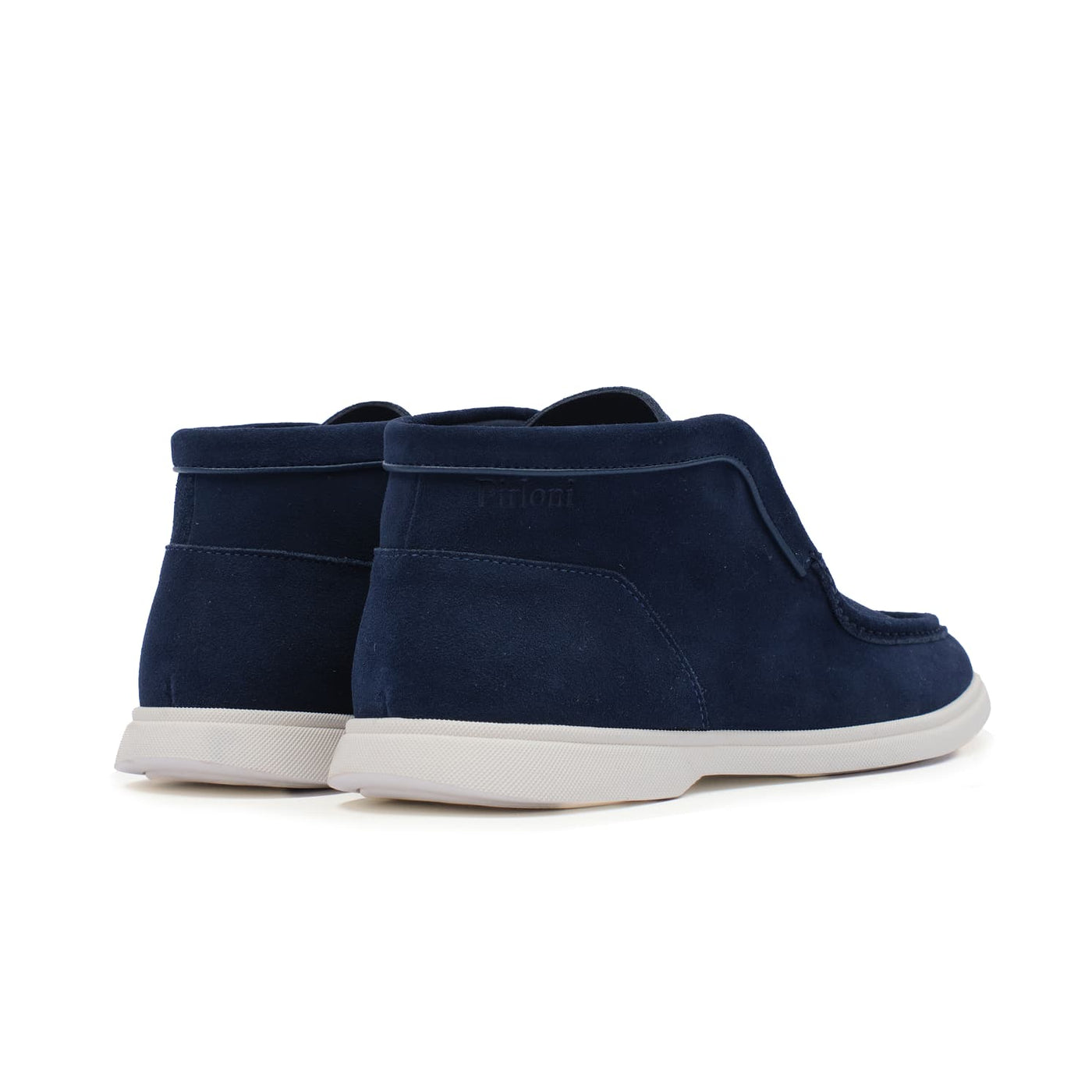 Pair of navy blue shoes with white soles on a white background