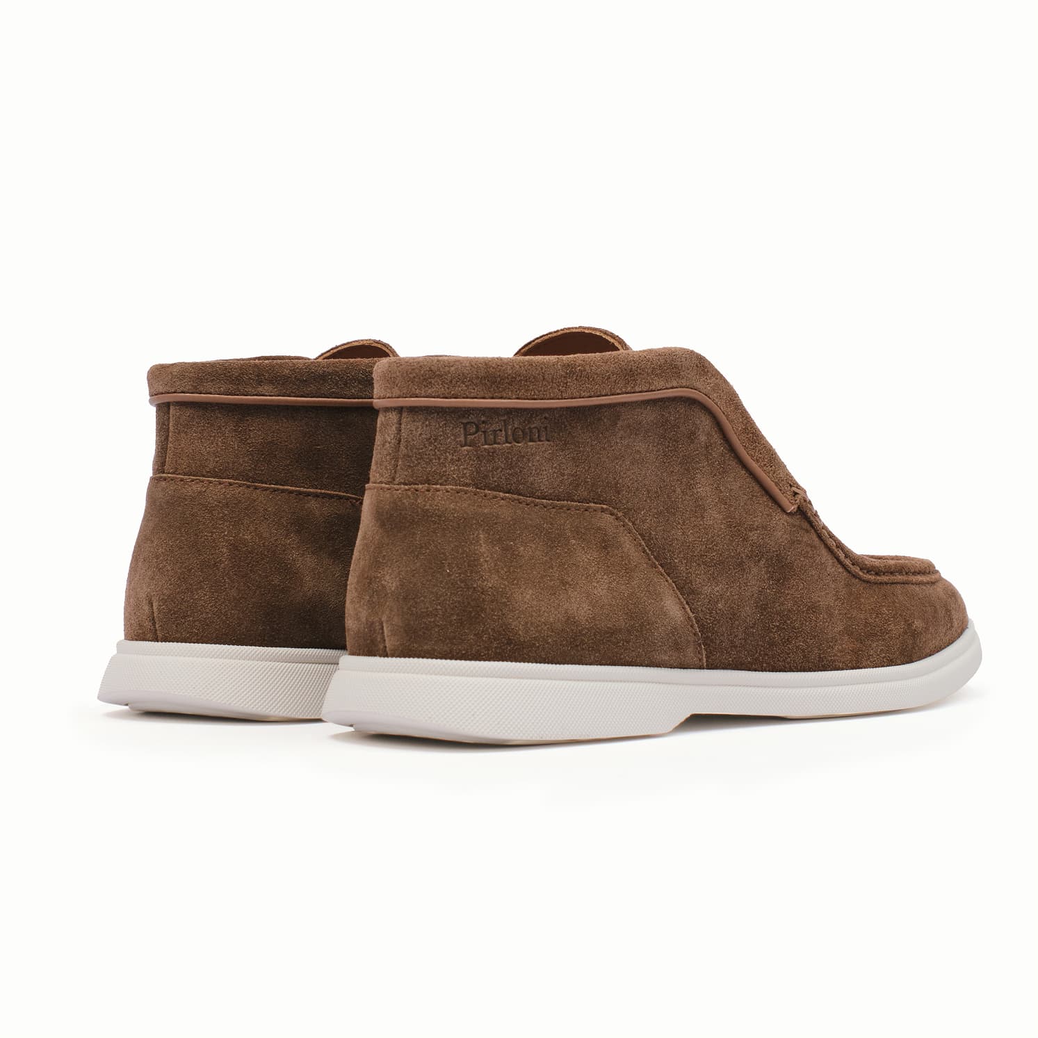 Pair of brown suede shoes with white soles on a white background