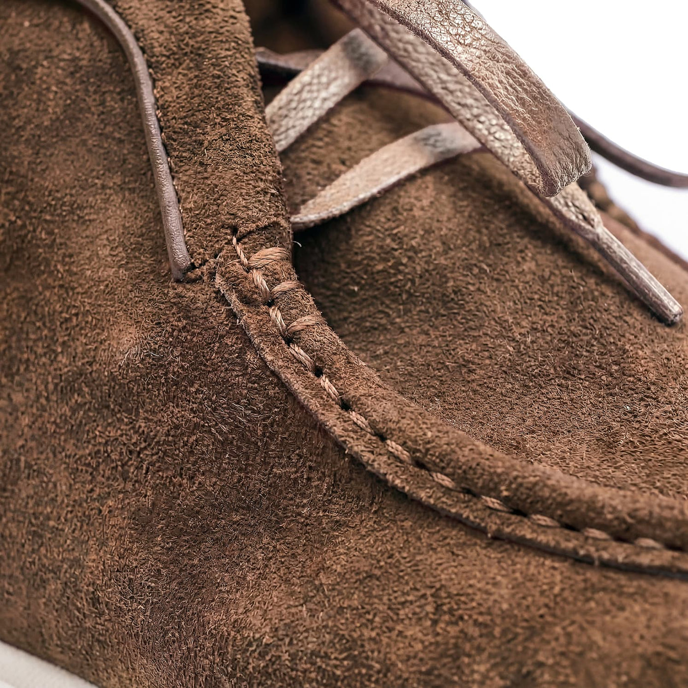 Close-up of brown suede shoes with visible stitching